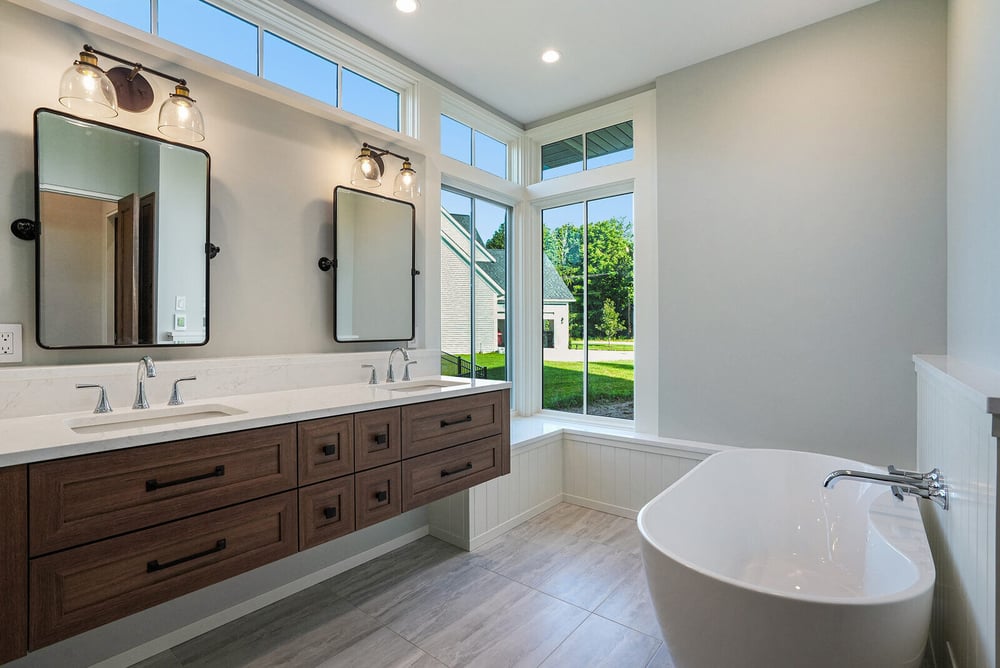 Luxurious bathroom with freestanding tub and double vanity, designed by R Value Homes in West Michigan