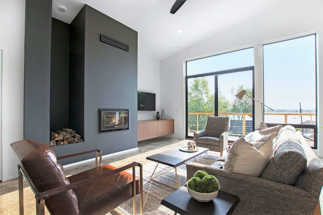 Living Room Design in Modern Concrete Home by R Value Homes, West Michigan with Custom Fireplace