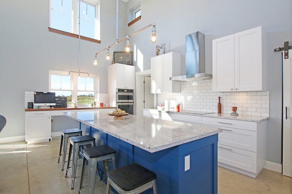 Spacious modern kitchen in a custom West Michigan home by R-Value Homes, with a large island and bright lighting