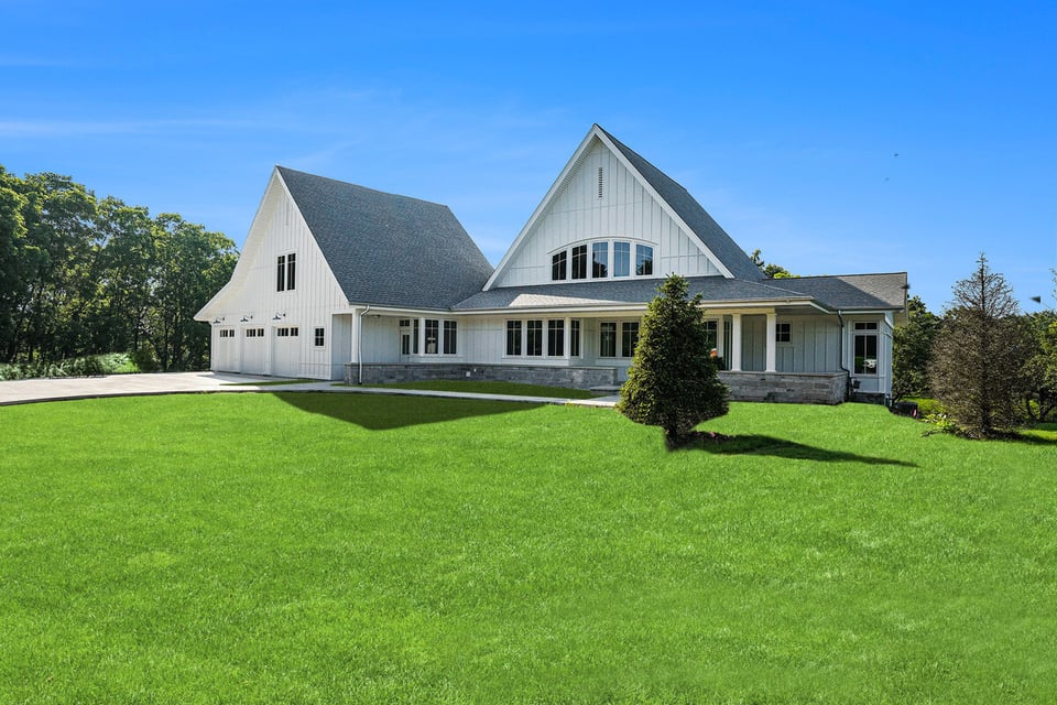 Front view of a modern custom home with green lawn, custom-built by R-Value Homes in West Michigan