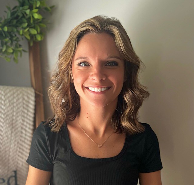 Portrait of Allyson smiling indoors, part of the R Value Homes team in West Michigan