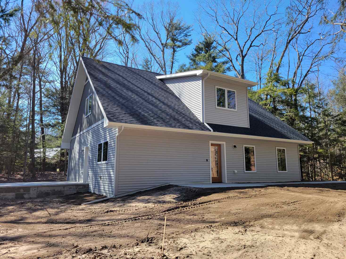 Modern custom home nestled among trees by R Value Homes in West Michigan