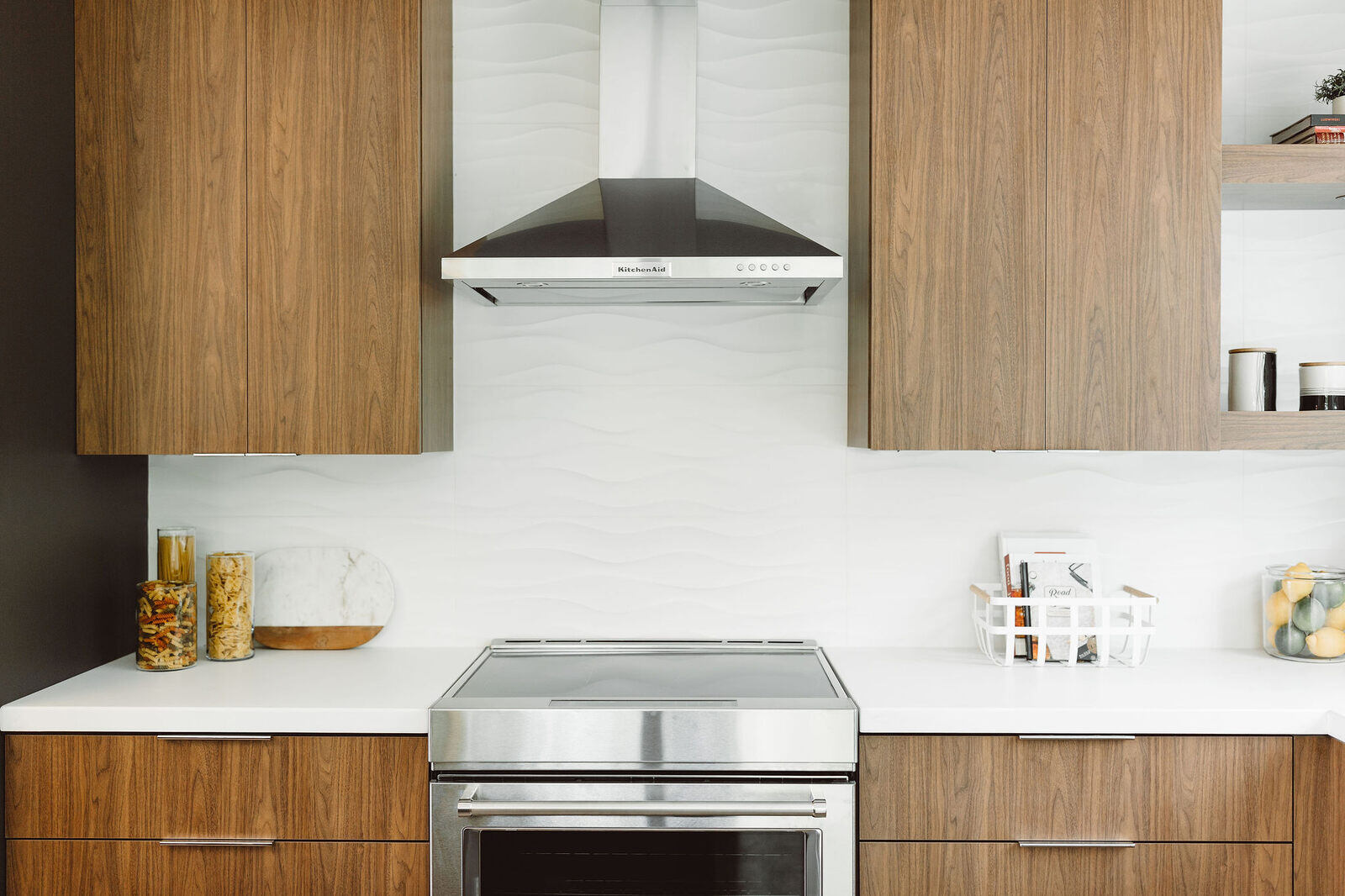 Modern kitchen with wooden cabinets and a clean backsplash, designed by R Value Homes in West Michigan