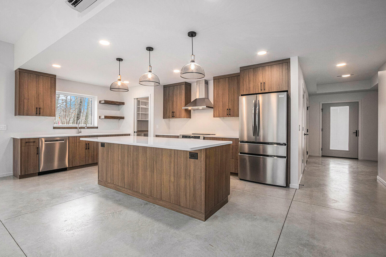 Contemporary kitchen with stainless steel appliances in a custom West Michigan home by R Value Homes