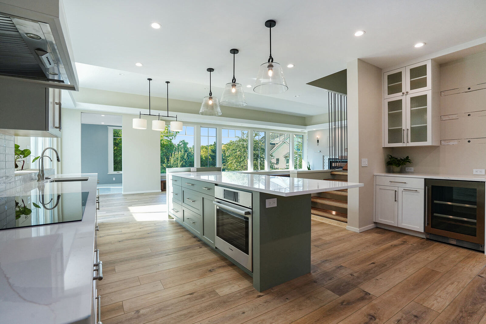 Open-concept kitchen with pendant lighting and hardwood flooring, built by R Value Homes in West Michigan