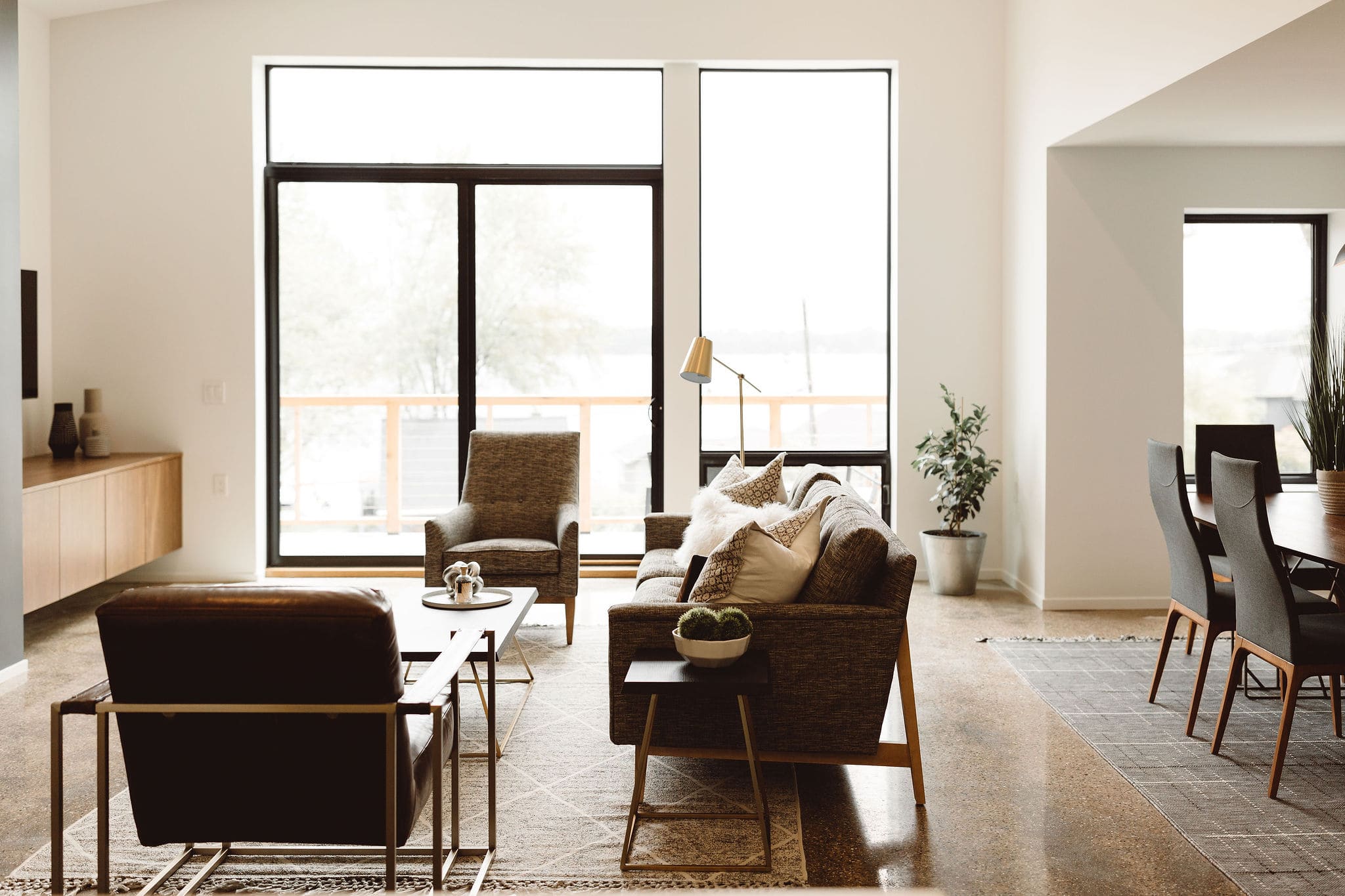 Living Room with Large Windows in Modern Concrete Net Zero Home in West Michigan by R Value Homes