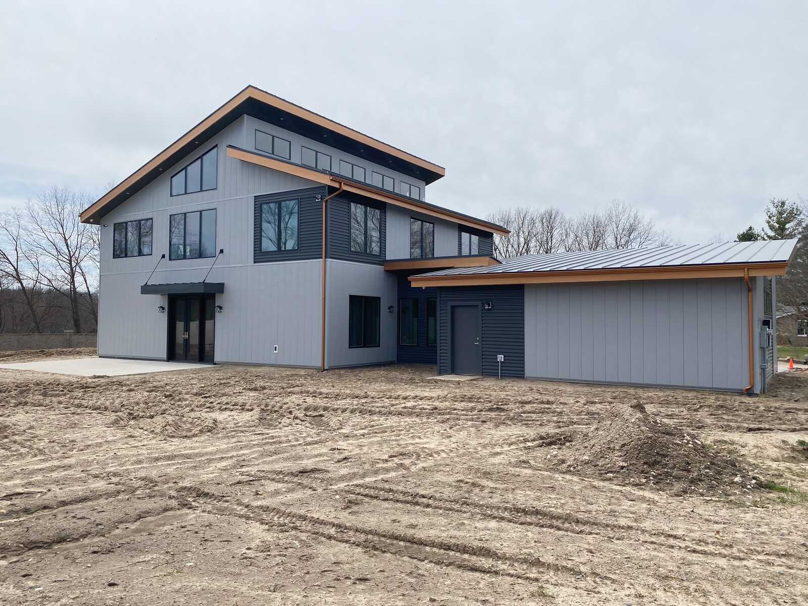 Exterior view of a modern custom home with unique architectural lines, built by R Value Homes in West Michigan